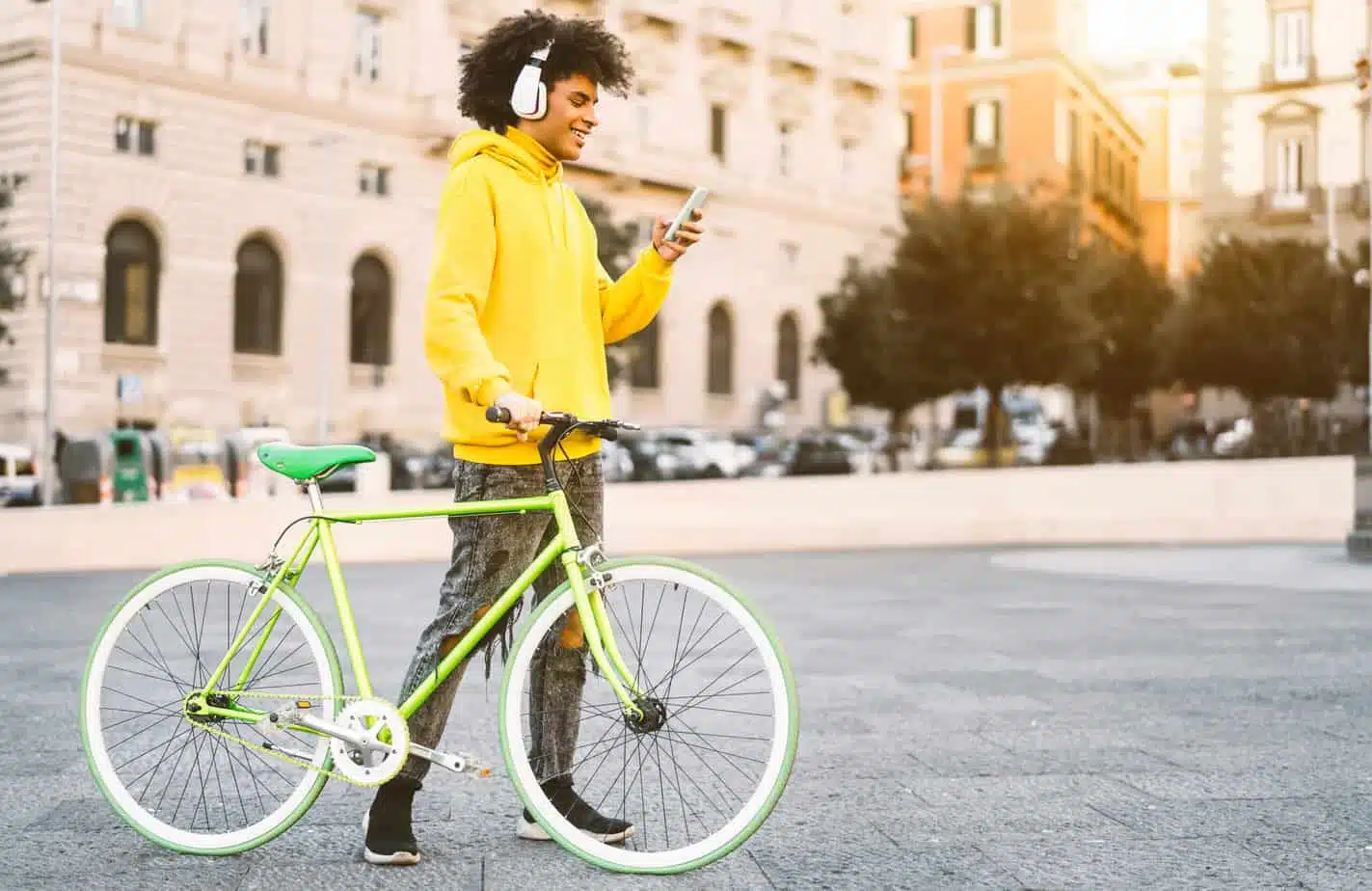 Happy Afro man using mobile smartphone outdoor - Young guy havin → Social Kings Grow your following